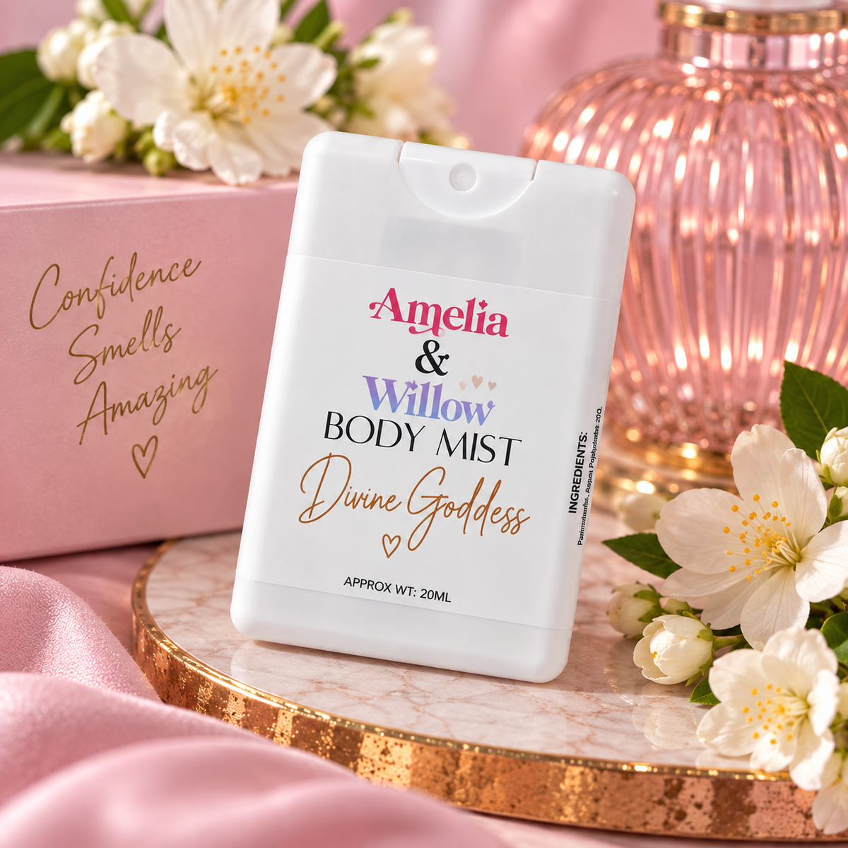 Divine Goddess 20ml body mist by Amelia & Willow held against a pink floral background