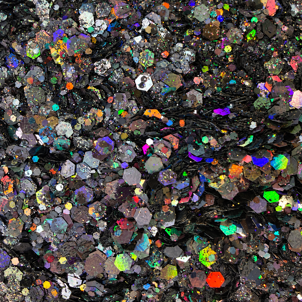 Close-up of Cosmic Noir craft glitter showing black and charcoal hexagons with colourful rainbow holographic reflections.