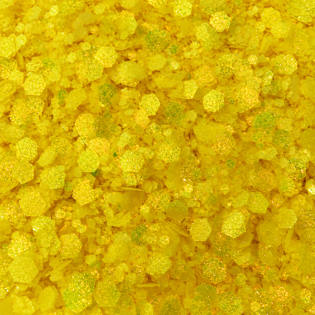Close-up of Sunshine State craft glitter showing bright lemon-yellow hexagons in mixed sizes with fine shimmering particles.